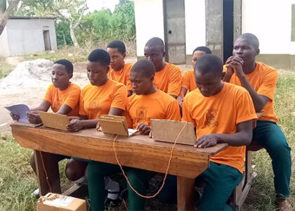 students at computers outside