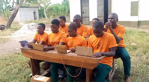 students at computers outside